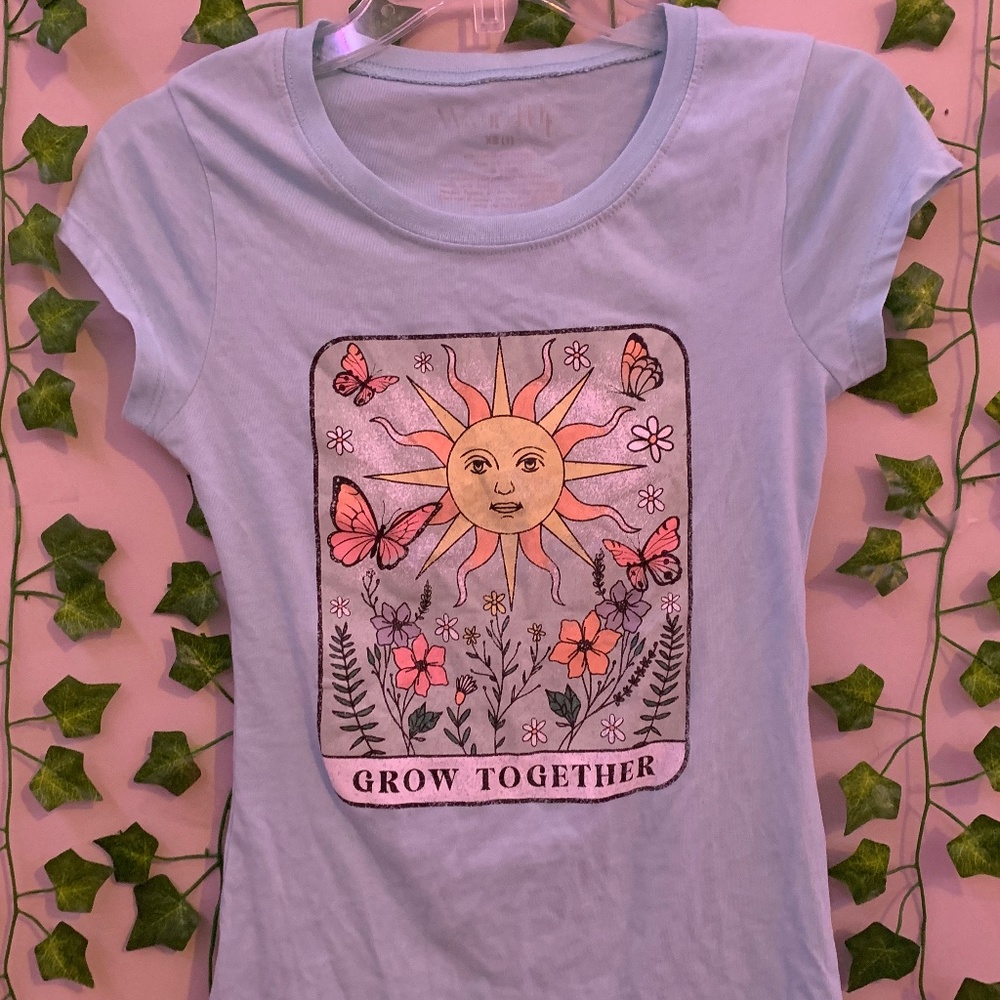 Is a teal shirt that the brand is wound up extra small